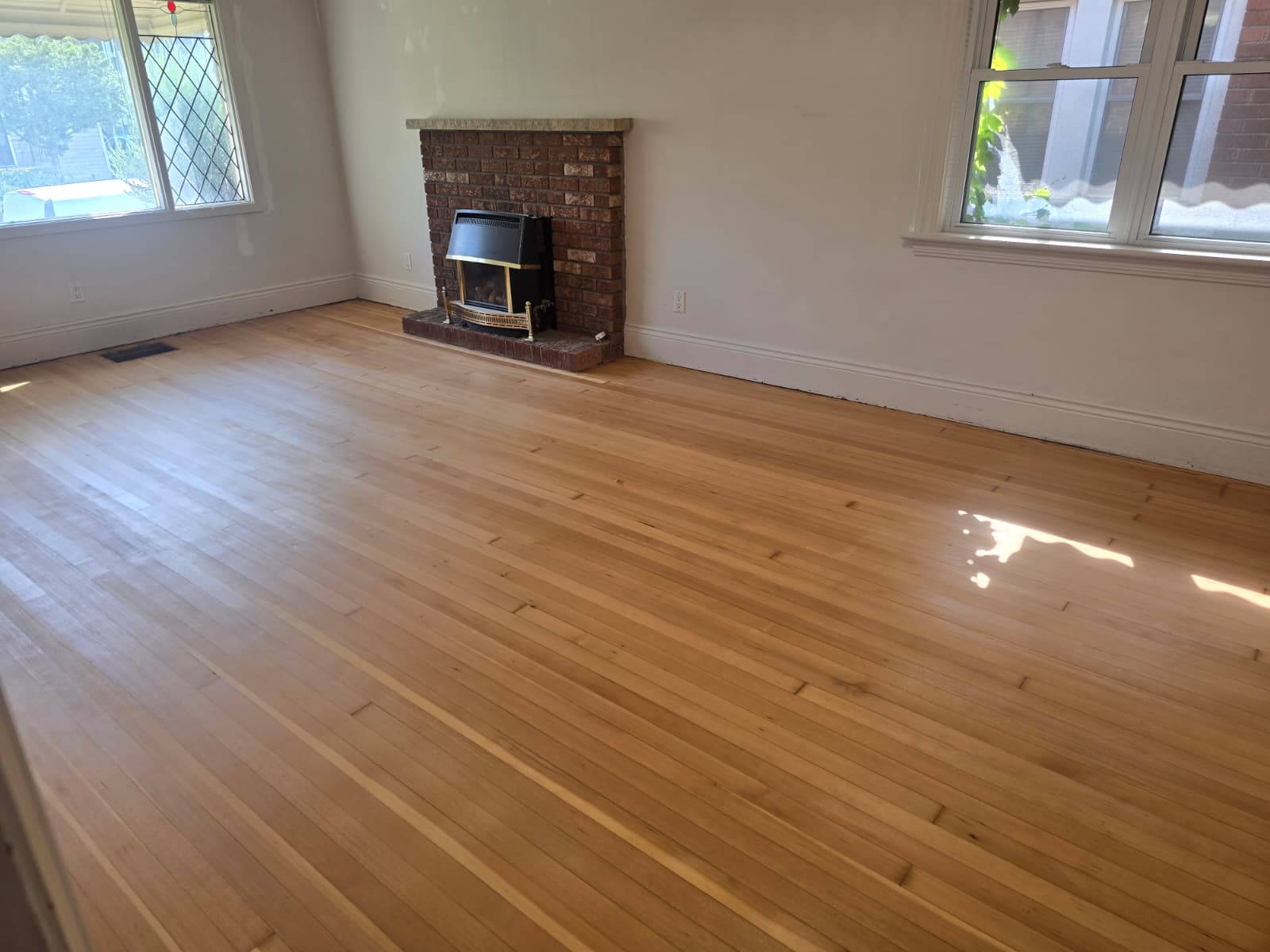 Refinished hardwood floor with warm tone in rowhouse in Washington, DC