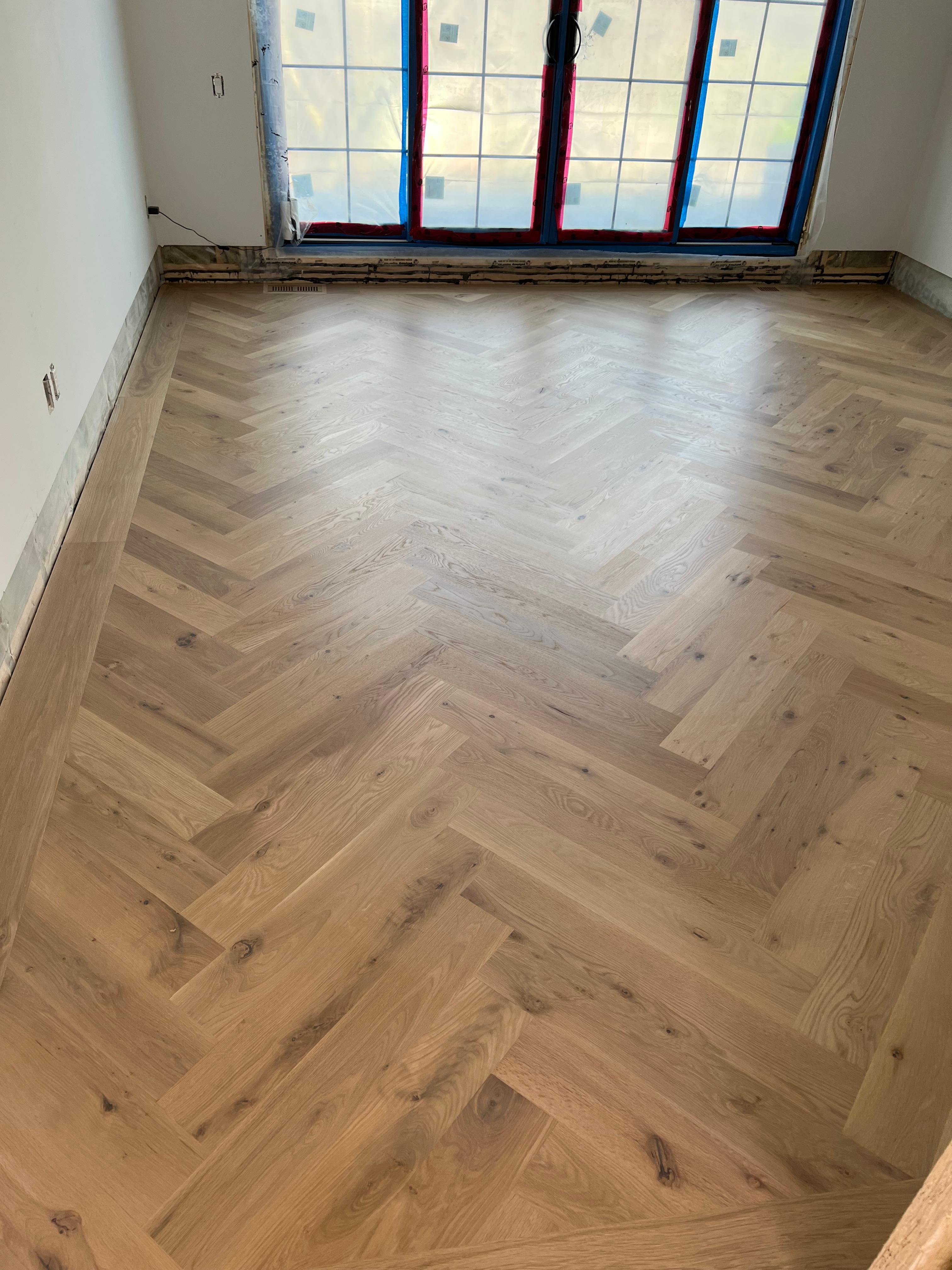 Hardwood floor filler being applied by a worker in Capitol Hill, Washington, DC home