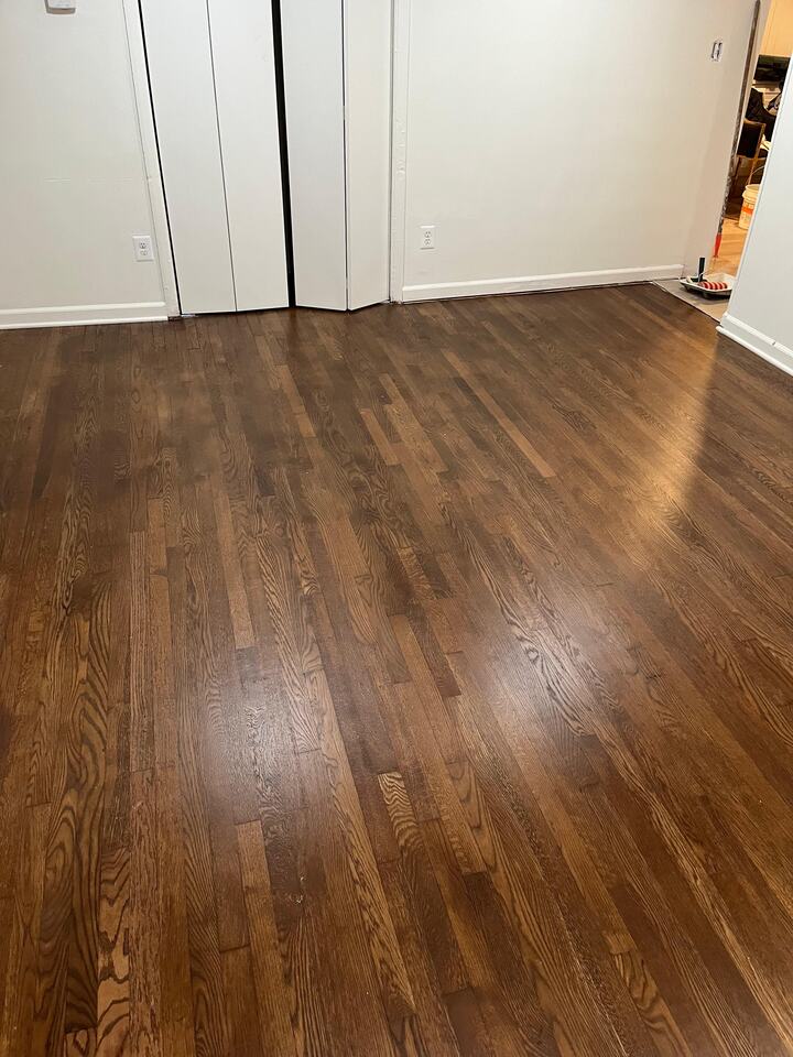 Sanded and refinished hardwood floor stained a rich tone in Fairfax, Virginia home