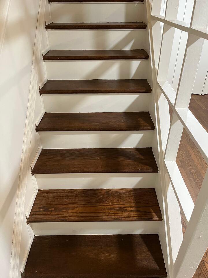 Chevron-patterned hardwood floor refinished with a natural sealer in Alexandria, Virginia home